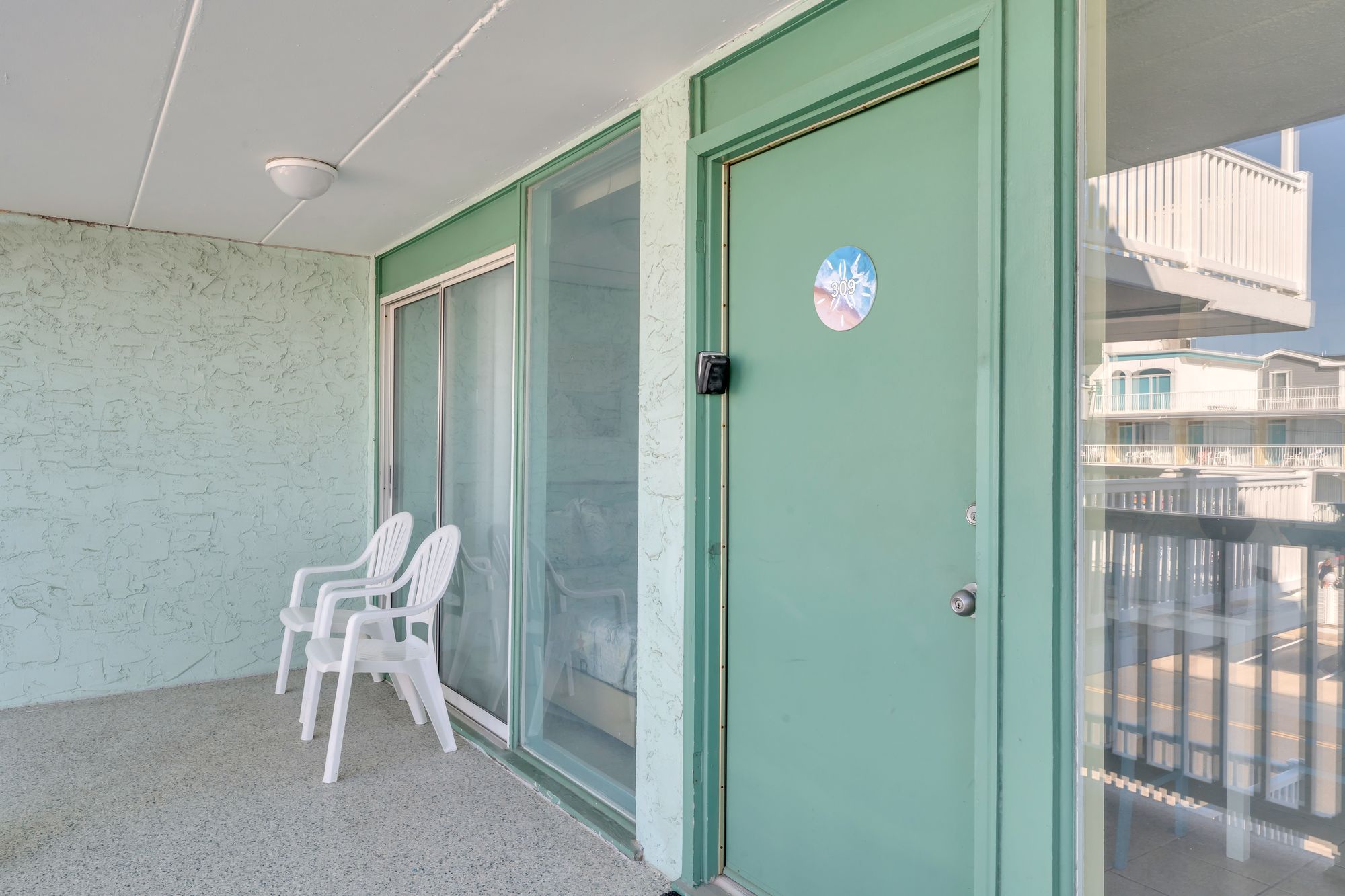 Private balcony with chairs outside Unit 309
