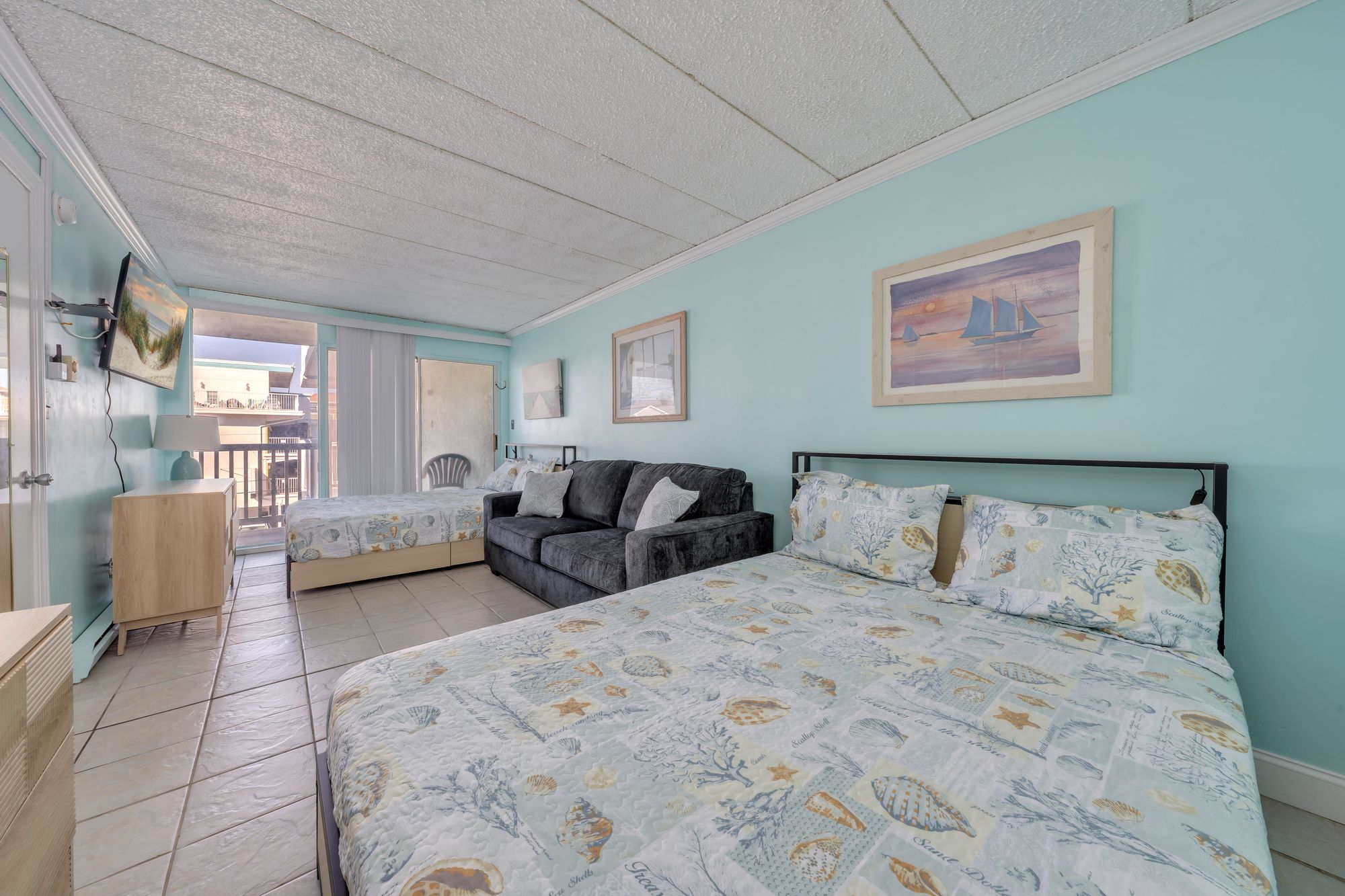 Wide view of the bedroom with both queen beds and the sleeper sofa