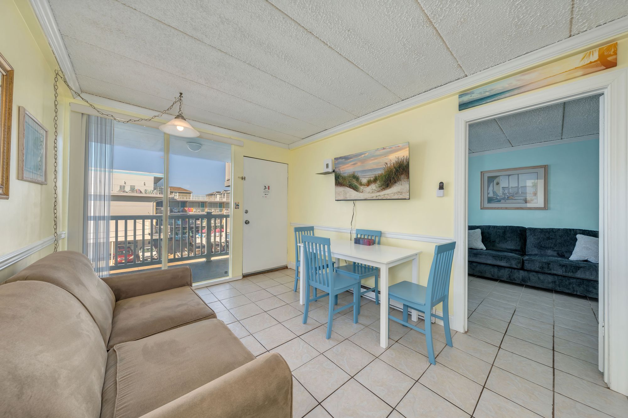 Living room and dining area with the balcony door