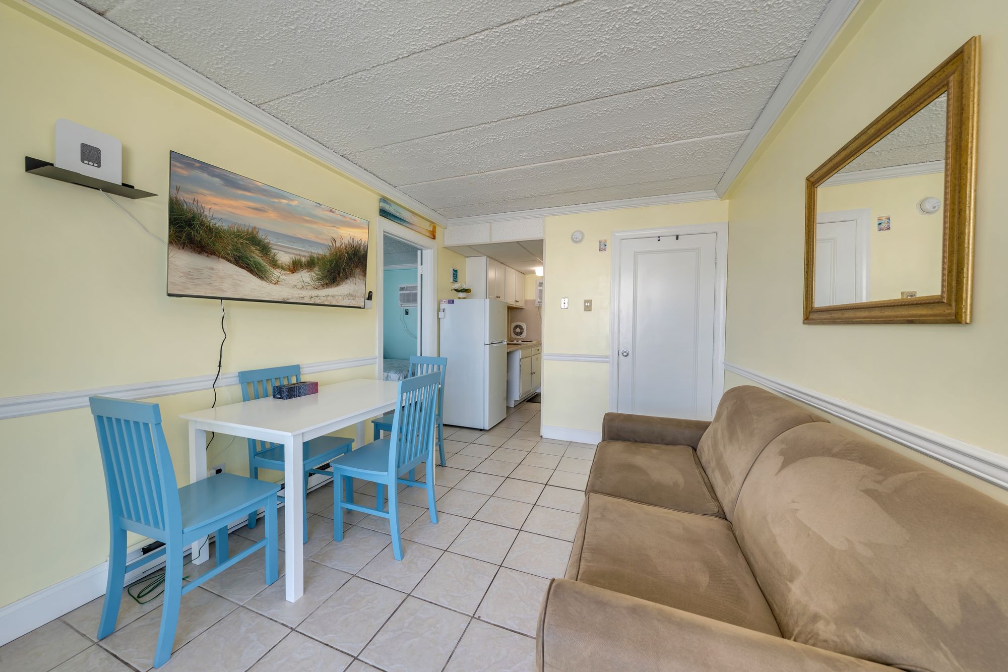 Living room with a full sleeper sofa, TV, and dining table